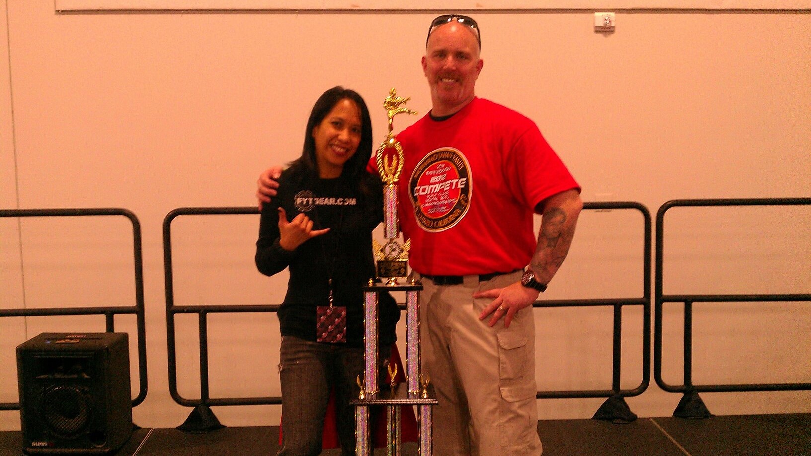 Gigie Baker standing next to a trophy.