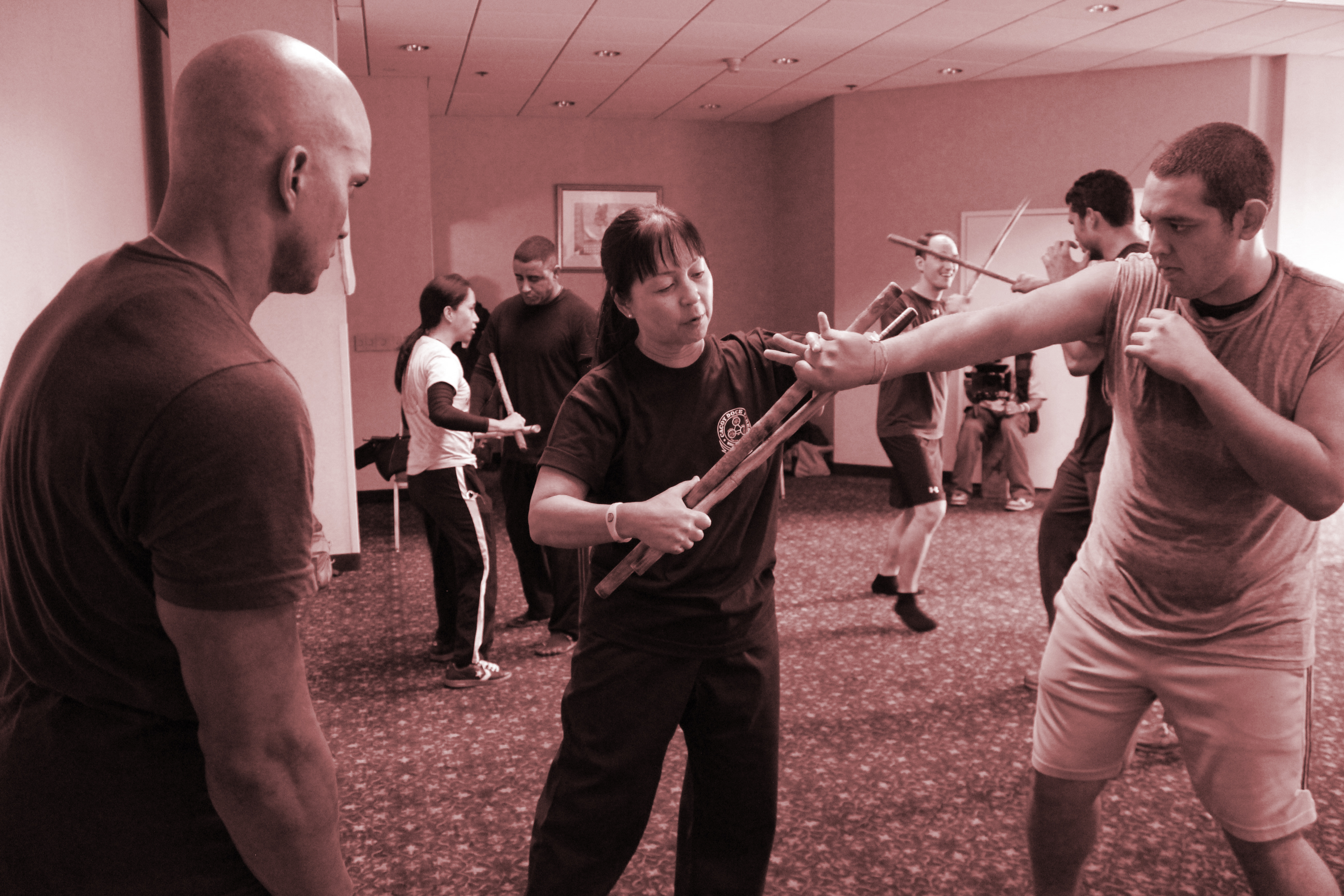 Photo of two men practicing martial arts involving a large blade weapon.