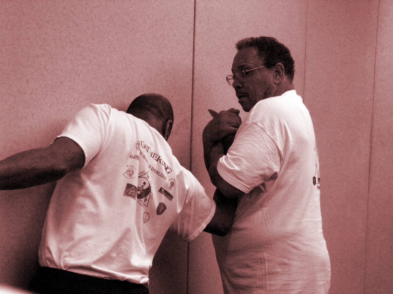 Photo of two men practicing martial art combative skills.